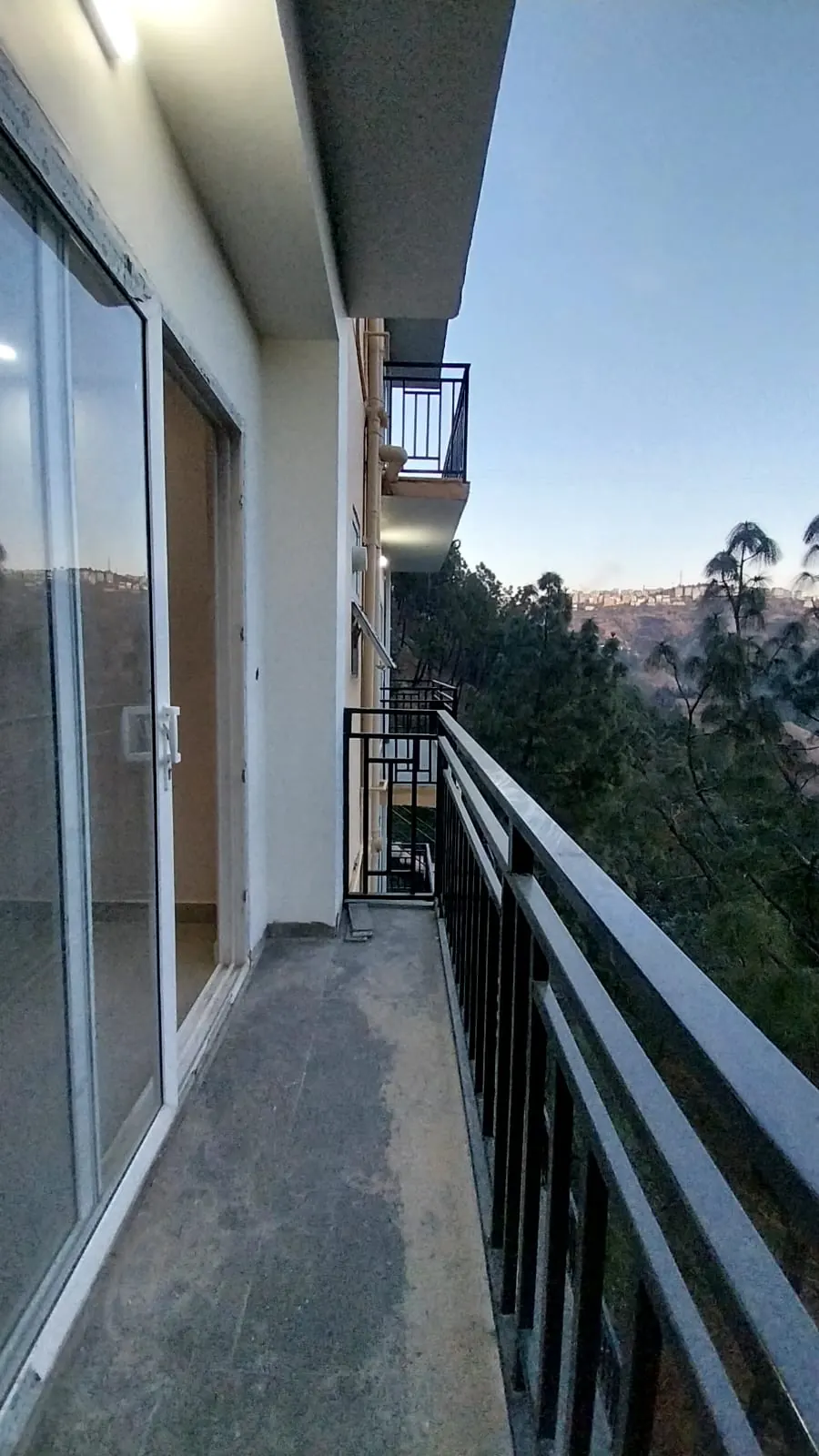 Balcony looking over the forested valley at dusk