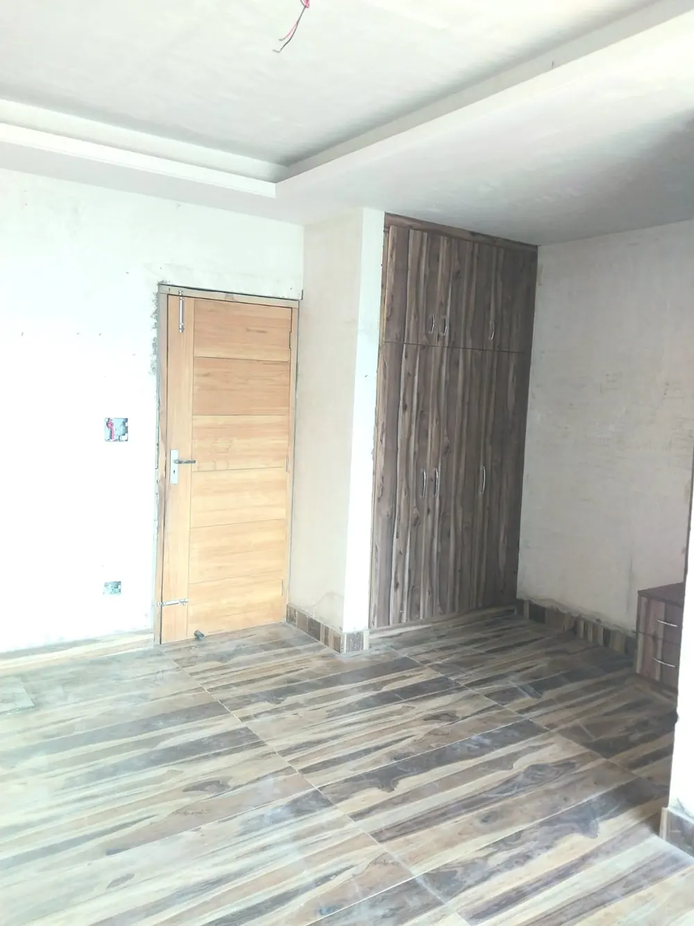 Bedroom with wardrobe and wooden door